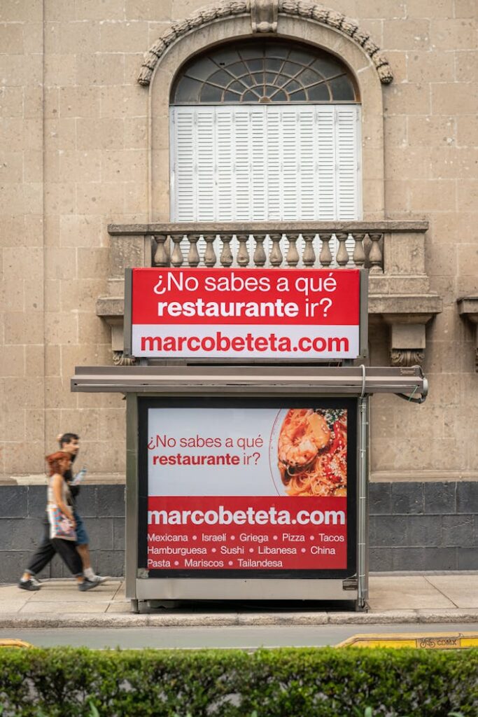 pexels-photo-16345653 Urban street scene featuring a restaurant advertisement on a building in Mexico City.