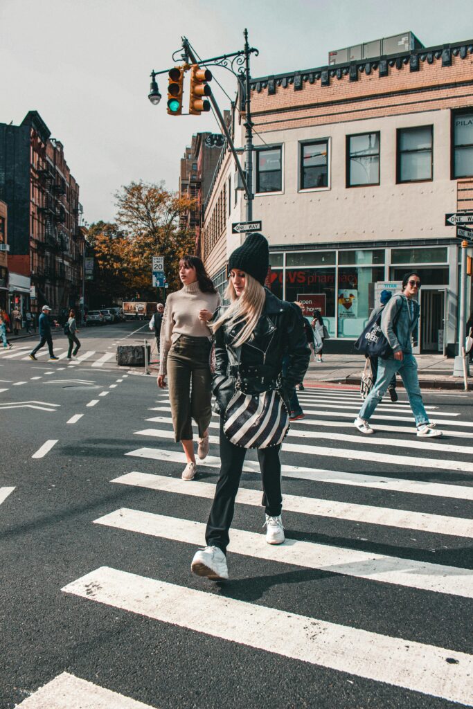 pexels-photo-3171622-3171622 People crossing a busy street in a vibrant city setting during the day.
