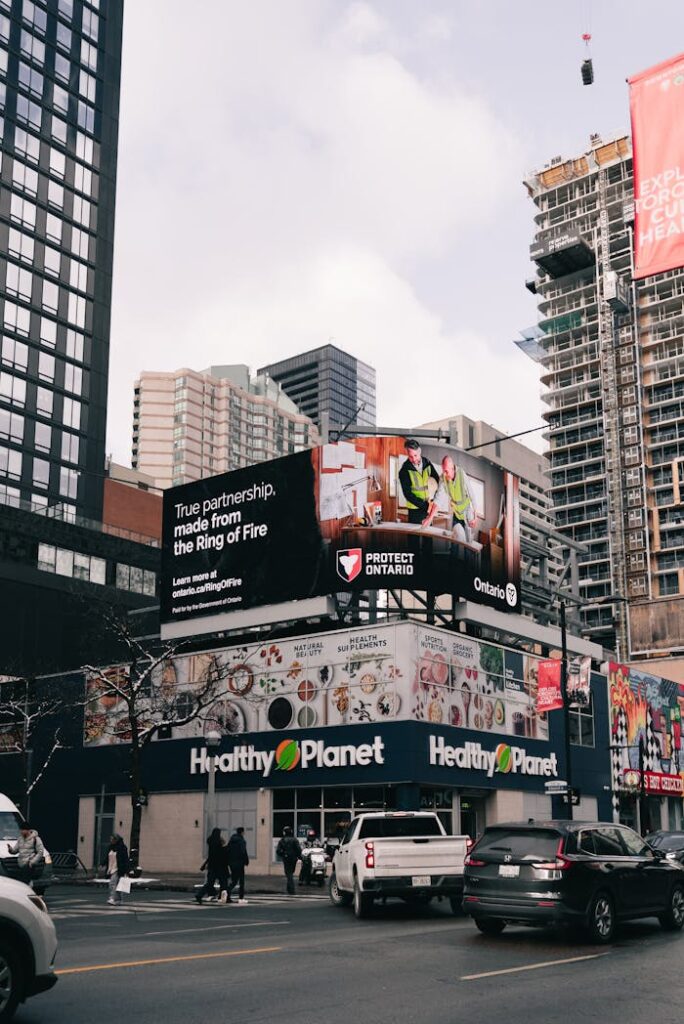 pexels-photo-35038788 Toronto street scene featuring a digital billboard above a busy intersection.